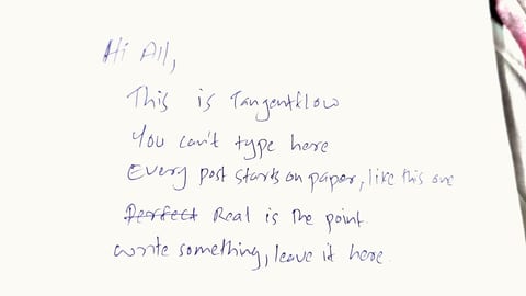 A piece of white paper with handwritten text in blue ink.